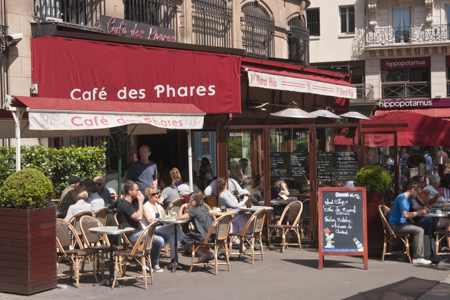 Helpful tips for visiting Paris - from a local People sitting at a cafe in Paris, France