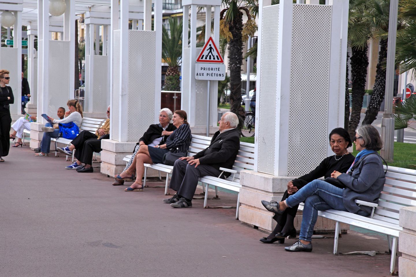 10 reasons to visit Nice in the Cote d'Azur People sitting and chatting on benches on the Promenade des Anglais in Nice, France