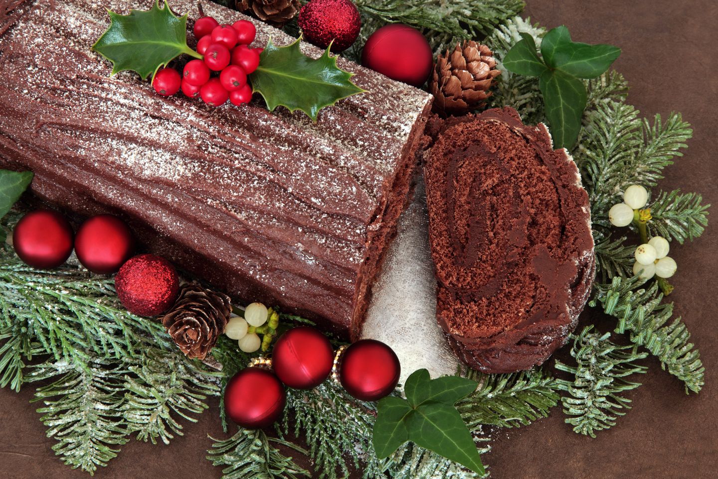 Christmas in France A bûche de noël or Yule log surrounded with Christmas decorations