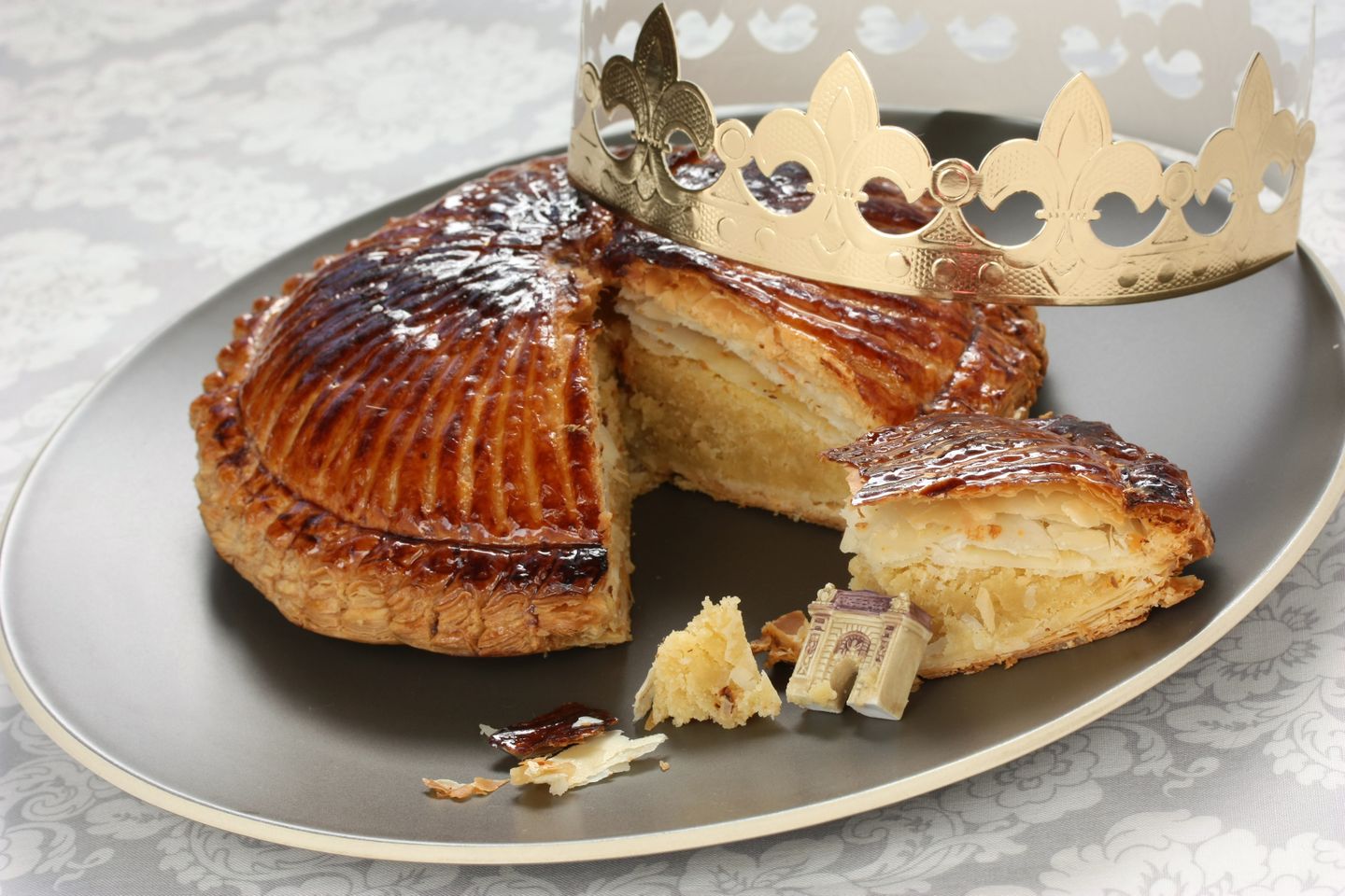 Christmas in France A Galette des Rois (or king cake) with a crown and figurine