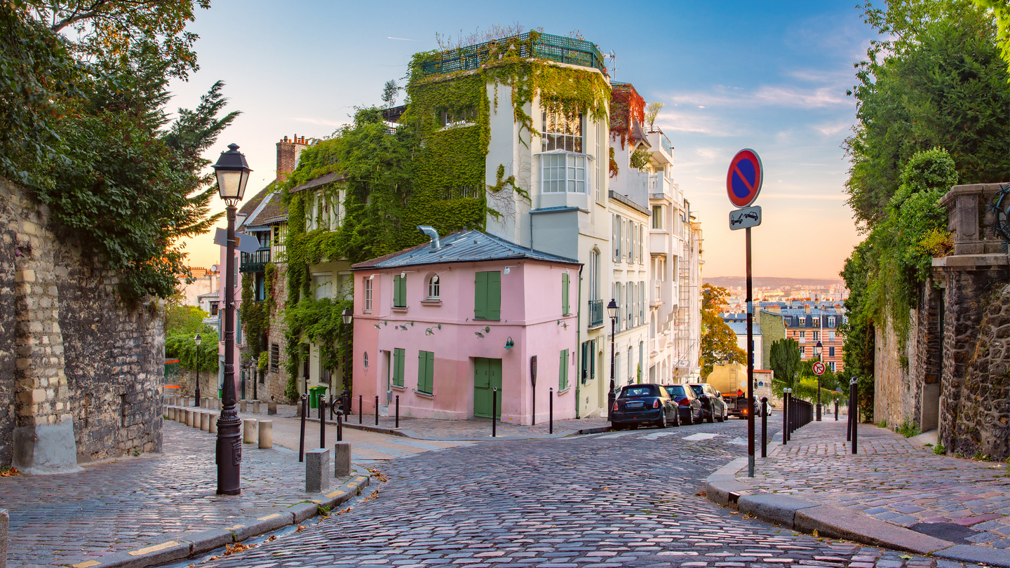 3 days in Paris: an itinerary for first-time visitors Old street with pink house at sunrise in Montmartre in Paris, France