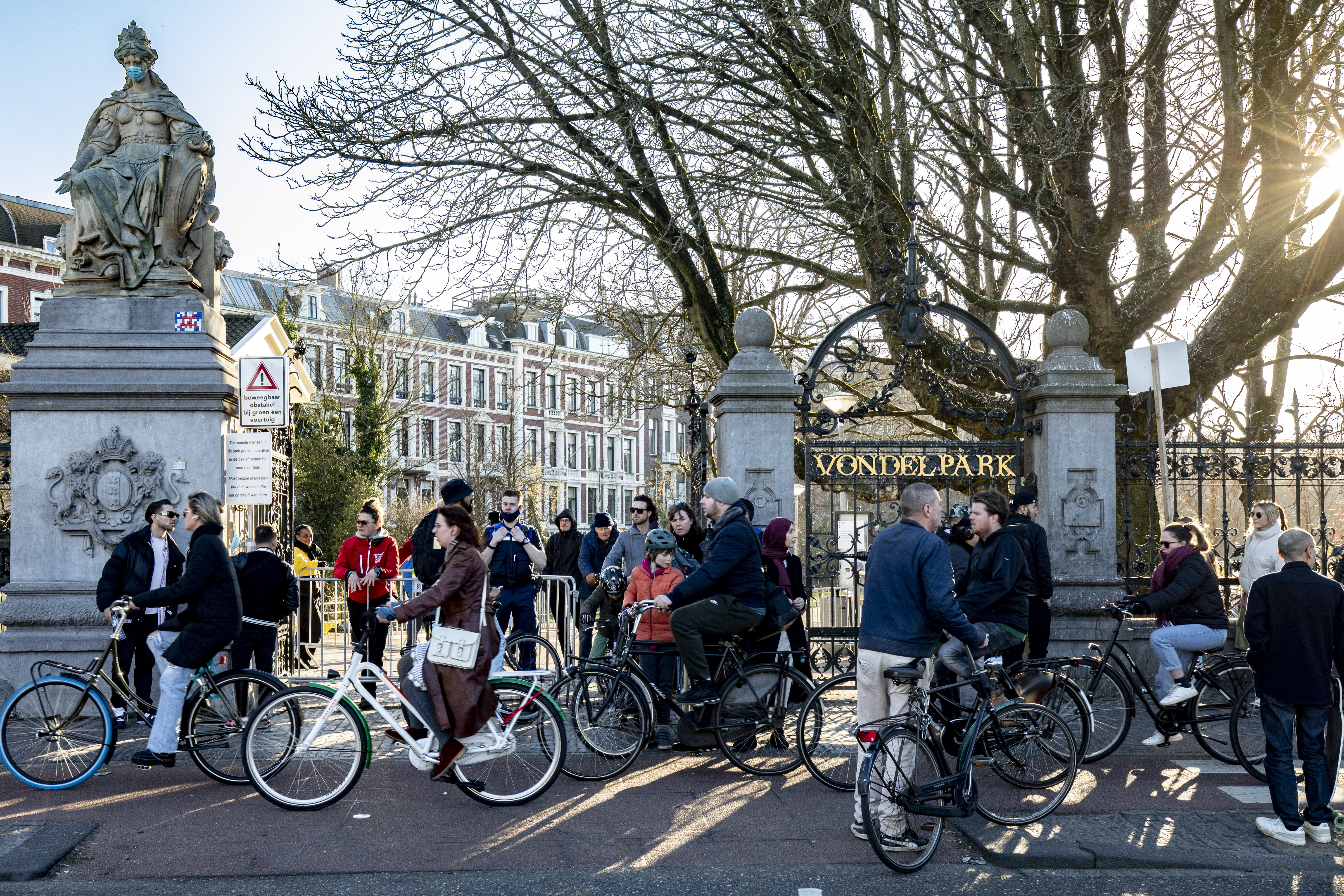Vondelpark Cyclists and people mingle around one of the entrances to Vondelpark in Amsterdam, which closed to the public during the Covid-19 pandemic